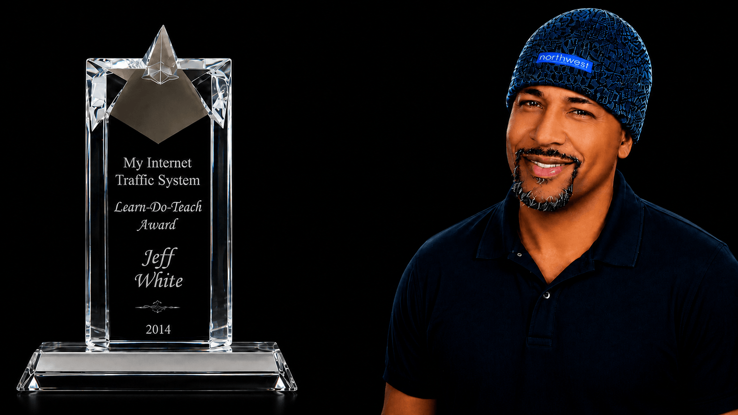 Jeff R. White smiling beside his 2014 Learn-Do-Teach Award